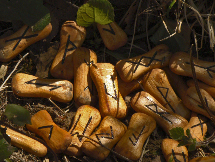 Wooden runes sitting scattered among grass